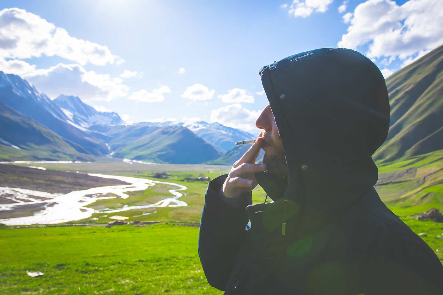 Man smoking a cannabis cigarette in the mountains