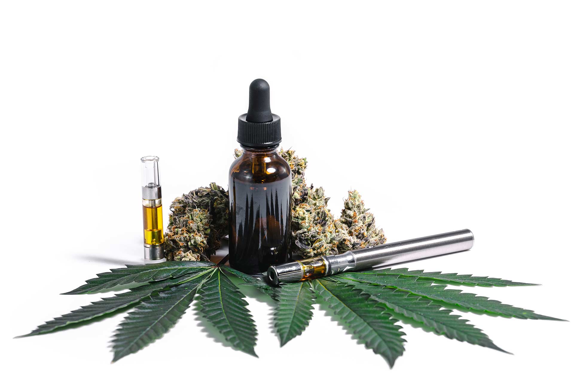 cannabis vape cartridge, cannabis tincture drop jar, cannabis flower and a cannabis vape pen sitting on top of two marijuana leaves